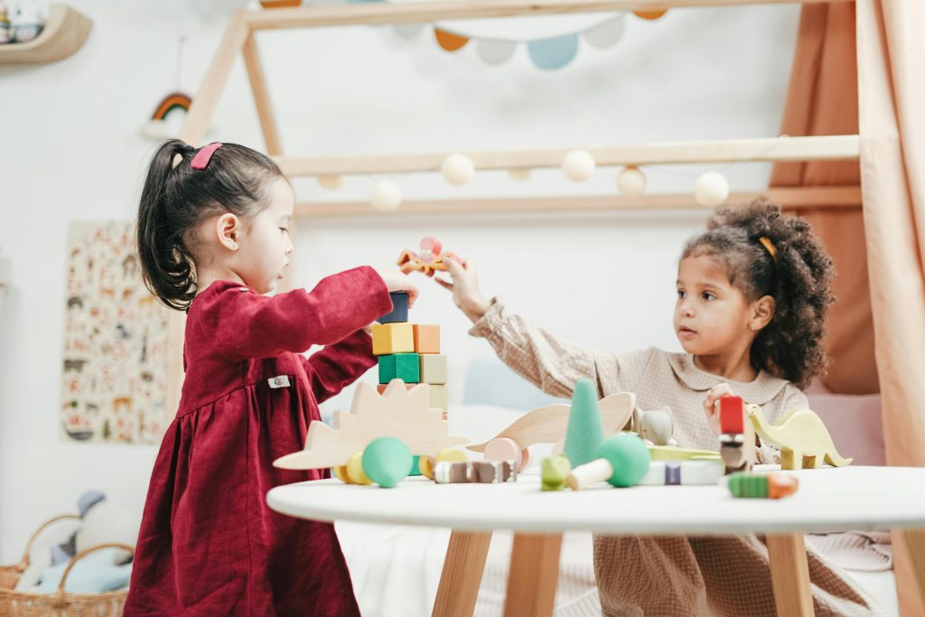 preschool children stacking wooden blocks